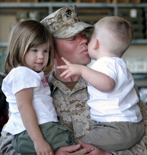 Military dad holding kids