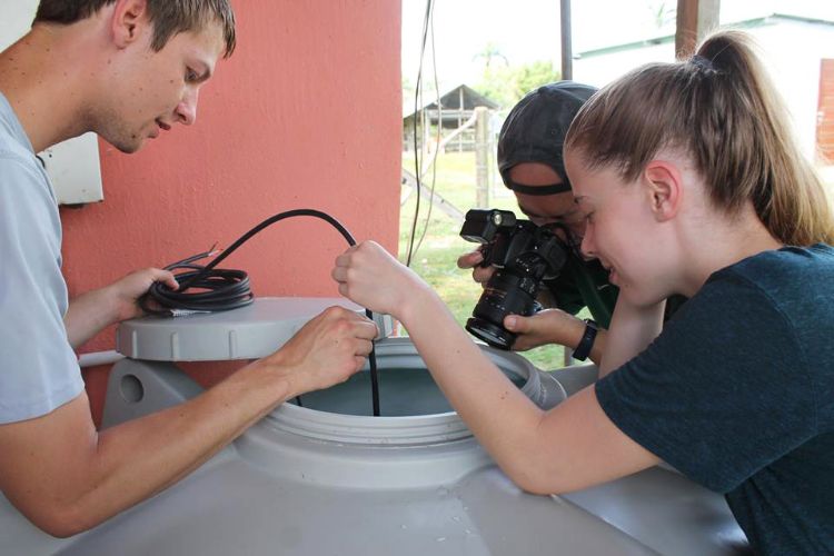 Students assessing water filter