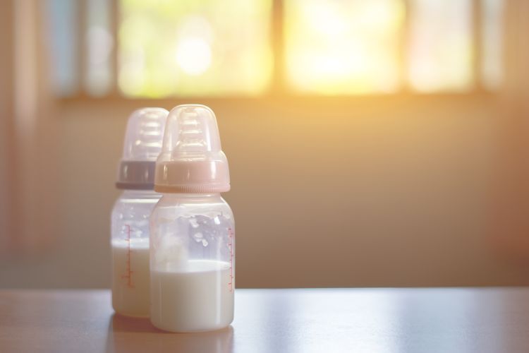 Two baby bottles sitting on a counter.