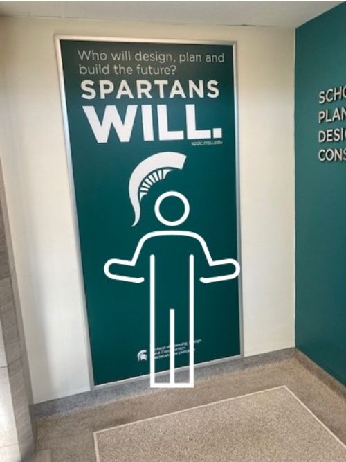 Stick figure in front of mural with Spartan helmet.