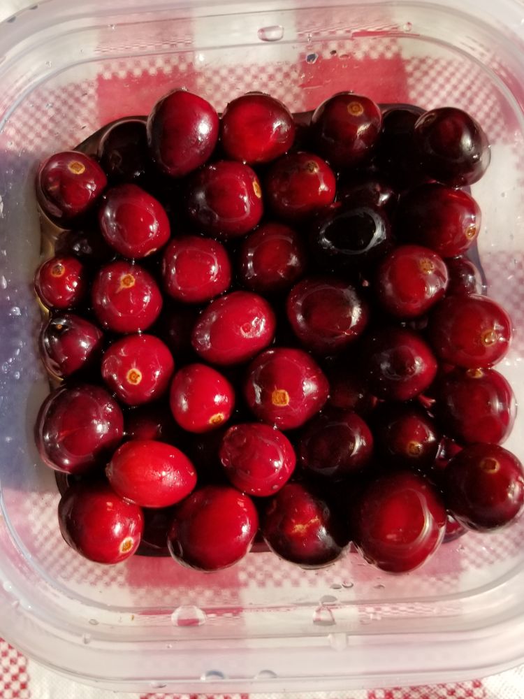 Cranberries in a glass container.