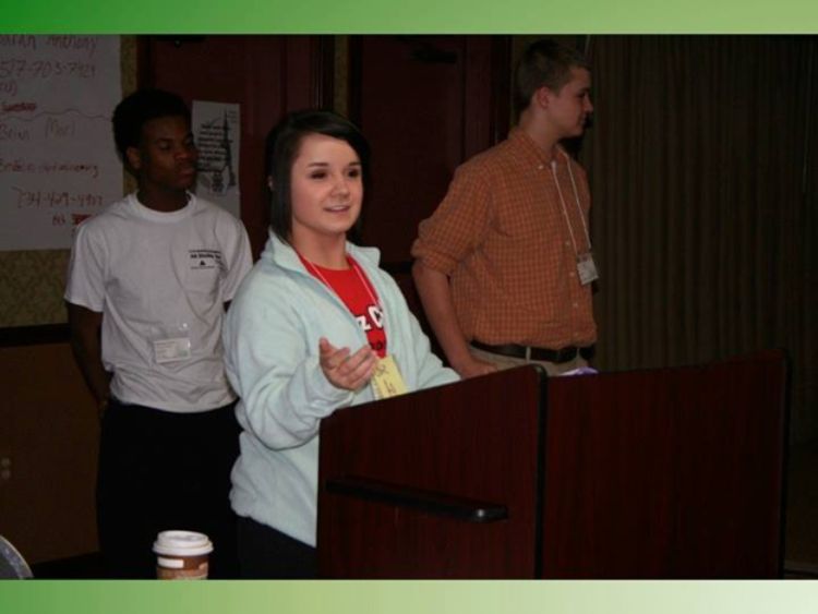 Young adult standing at podium speaking as part of the 4-H Capitol Experience.