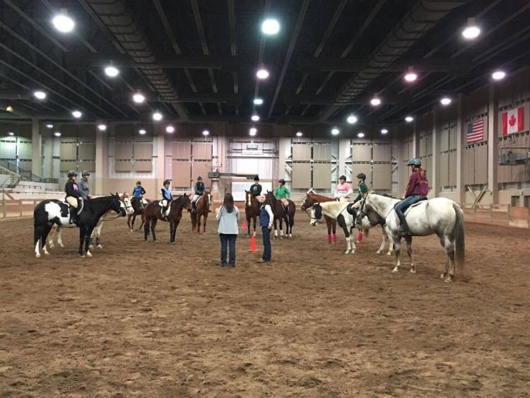 Clinician Jessica Pickford and event coordinator Taylor Fabus meet with riders of the 40th Annual Michigan 4-H Benefit Clinic. Photo: Alonna Maltinsky.