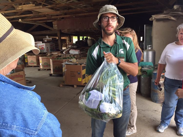MSU Extension educator Ben Phillips at Van Houtte Farms with Farm to Factory bag