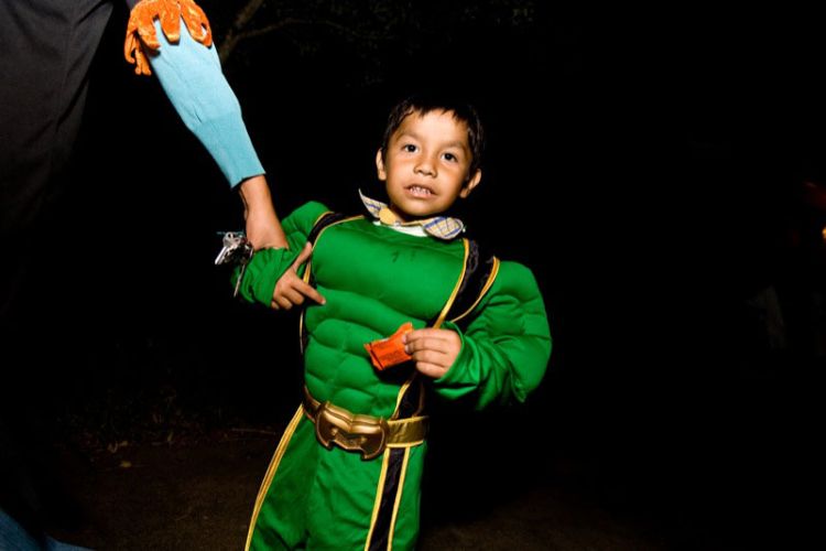 Child dressed in superhero costume for Halloween. | Photo courtesy of Flickr user Charlie Llewellin.