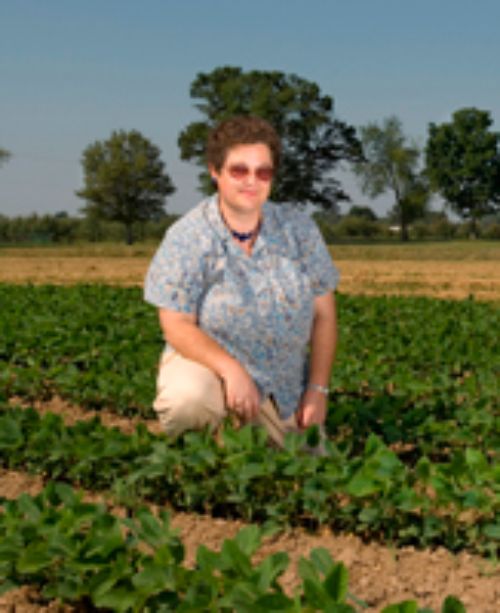 Sieg Snapp kneeling in a field