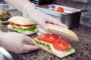 Sandwiches are prepared following food safety guidelines.
