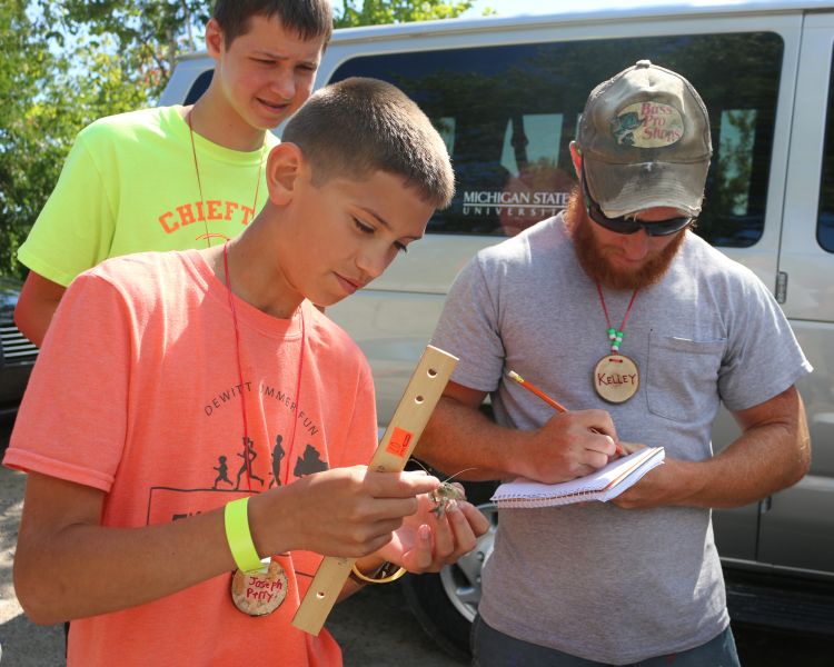 Campers work alongside Michigan State University researcher Kelley Smith, to collect and analyze crayfish from Presque Isle waterways. Brandon Schroeder | Michigan Sea Grant