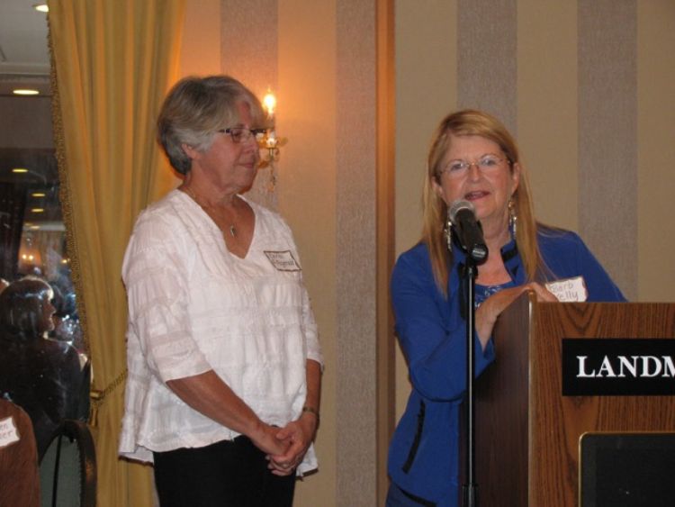 Advanced Master Gardener Carol Fitzgerald (left) accepts the 2015 Phil Niemisto Volunteer Award from Barb Kelley (right), awards committee chair of the Marquette Beautification and Restoration Committee. Photo by Tami Dawidowski.