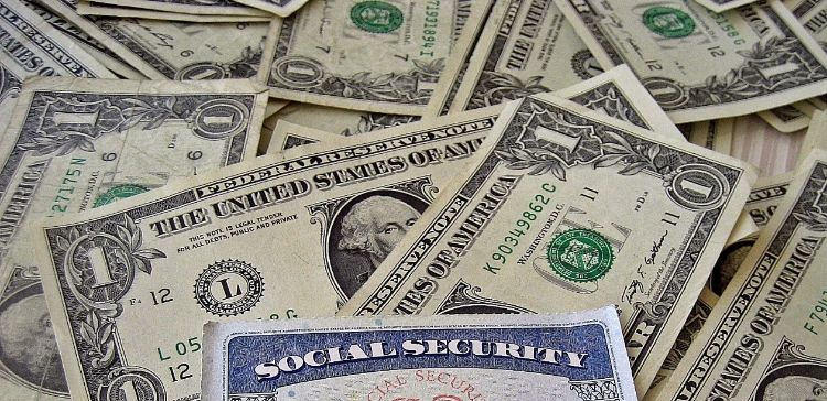 a pile of money and the edges of a social security card