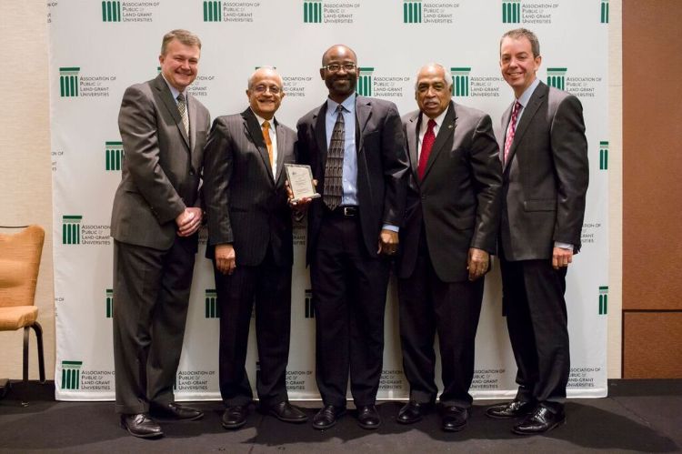 Titus Awokuse (center) at FLSI recognition ceremony