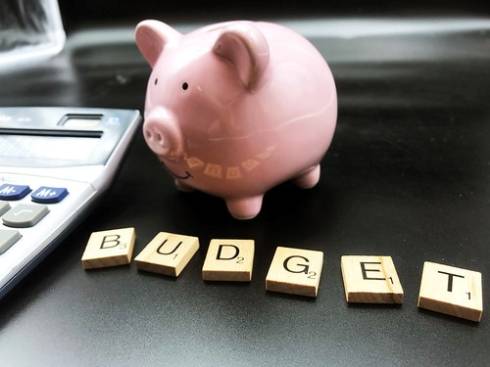 Piggy Bank with scrabble letters spelling out budget.