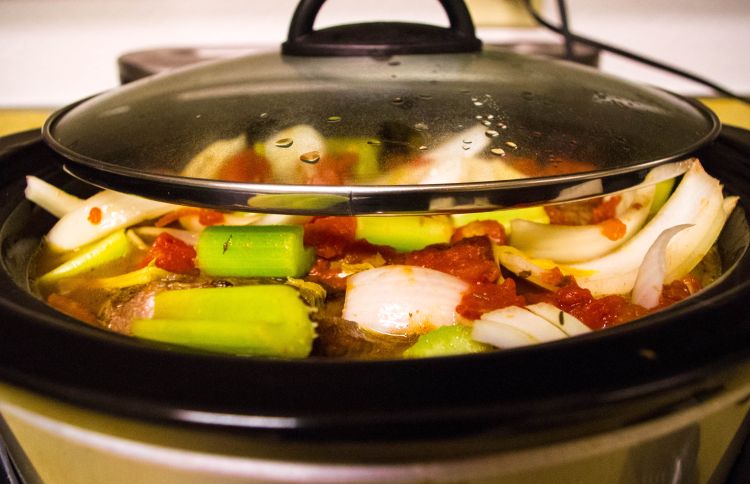 Various vegetables in a slow cooker.