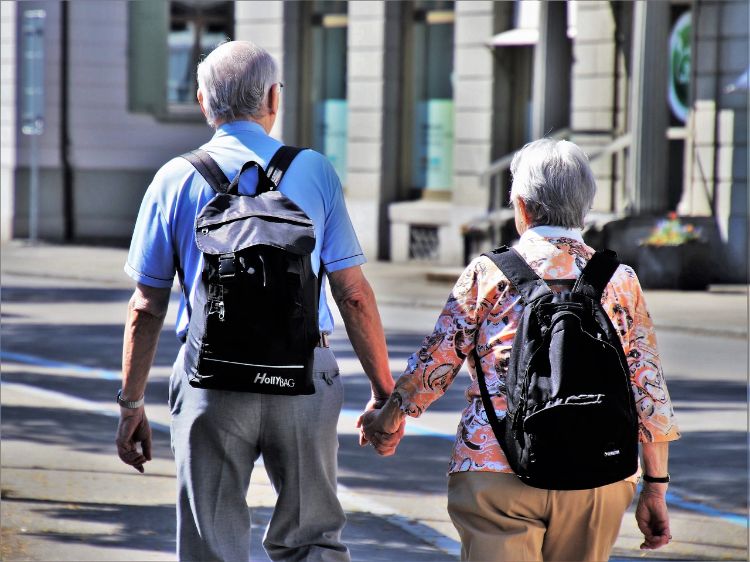 A senior couple walking outside.