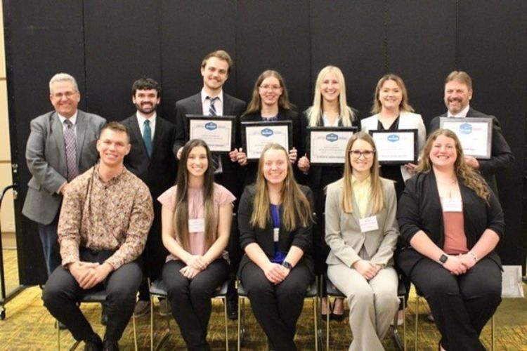 Ten MSU students and their two coaches posing for an awards photo.