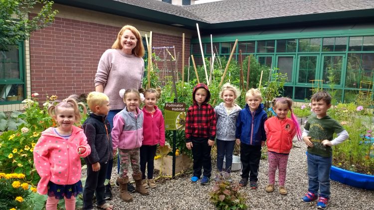 Elizabeth Slajus, advanced Extension Master Gardener, with children at the Woodland Childcare School Garden in Kingsford, Michigan. Photo by Sharon Quick-Dulan, Woodland Childcare Center director.