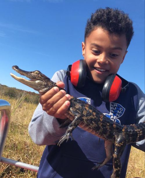 Ruell holding a wild alligator