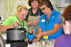 Youth learning the importance of food preservation safety.