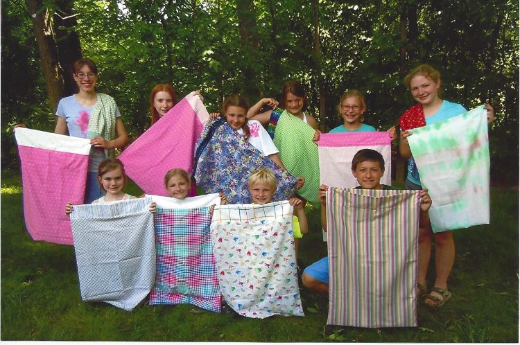 Members of the Midland County Happy Hands 4-H Club show off their stitched pillowcases.