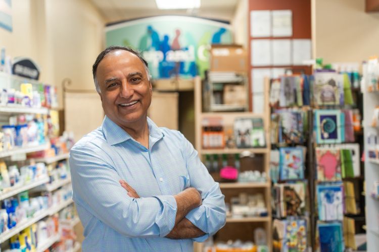 A photo of pharmacist Arun Tandon standing in his store.