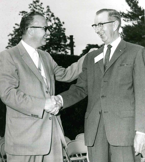 Casper “Cap” Blumer (right), Alcona County Extension director, shook the hand of Secretary of Agriculture Ezra Taft Benson as he received the U.S. Department of Agriculture Superior Service Award.