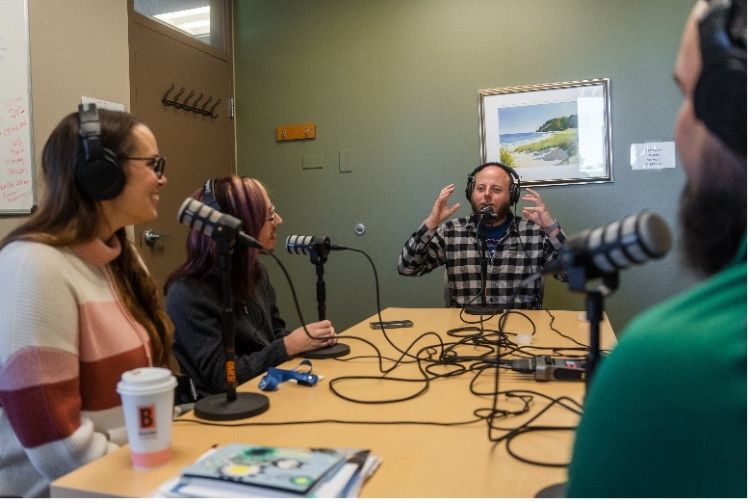 A program instructor from the Michigan Vaccine Project interviews members of Disability Network West Michigan for a podcast.