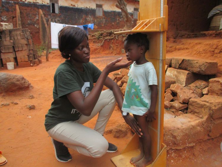 Mary Adjepong measures a child in Ghana