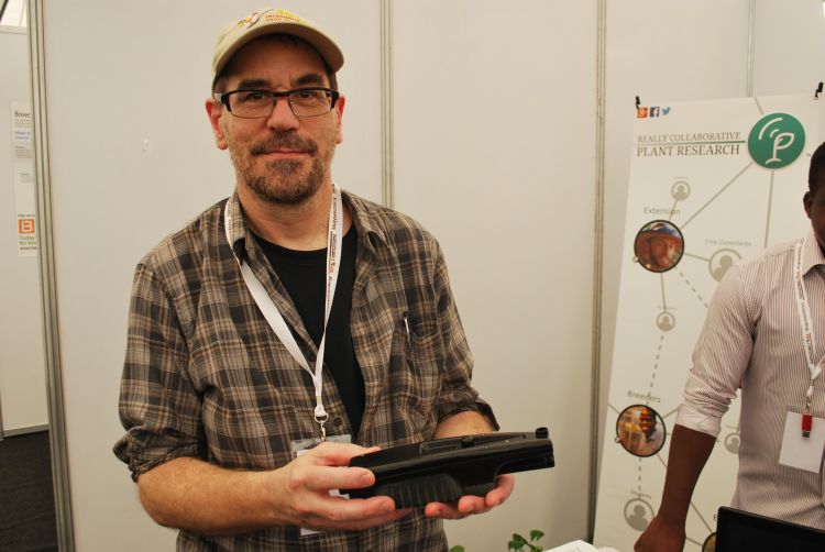 David Kramer holding the MultispeQ device used in PhotosynQ