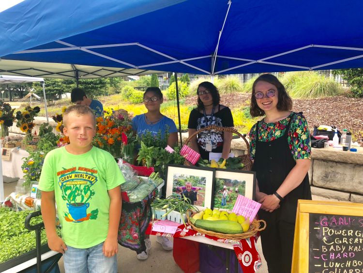 Students from the Food Systems Project at Northwest Initiative sell their produce at the Lansing Grown Pop-up market in July of 2018.