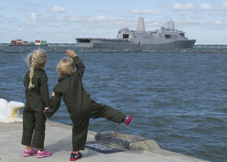Children waving to Navy ship
