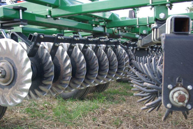 Vertical coulters cut and size residue while the rolling harrow levels the seedbed and distributes residue.