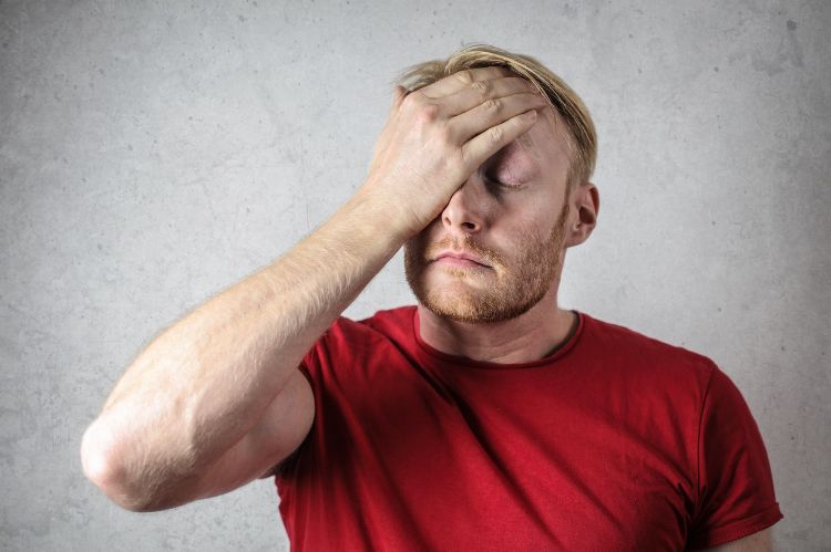 A man holding his head