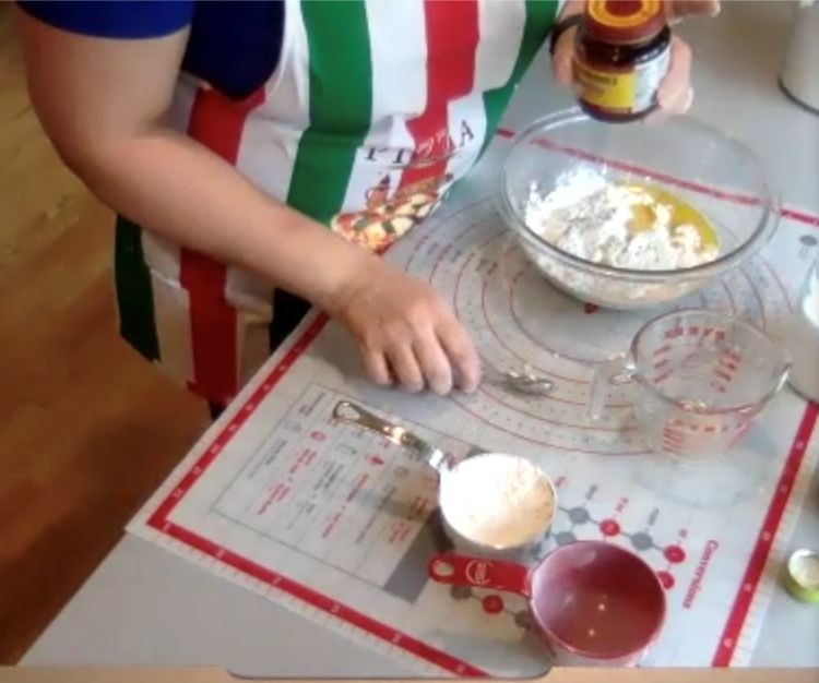 Carmen De Lorenzo demonstrating making pizza dough.