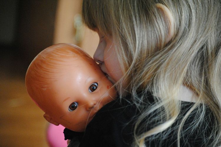 Modeling with a doll can help train a child on how to really act once the new baby arrives. Photo credit: Pixabay.