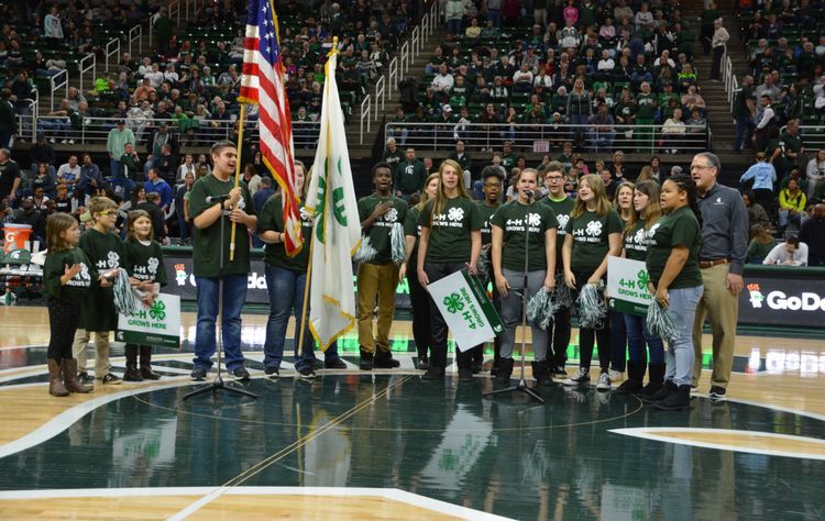 A group of 4-H youth standing at center court at the Breslin during a previous MSU Extension event.