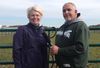 Karen Waite and Kraig Ehm stand in a pasture