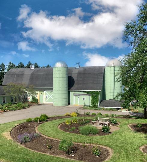 View of Tollgate Farm barn and rose garden