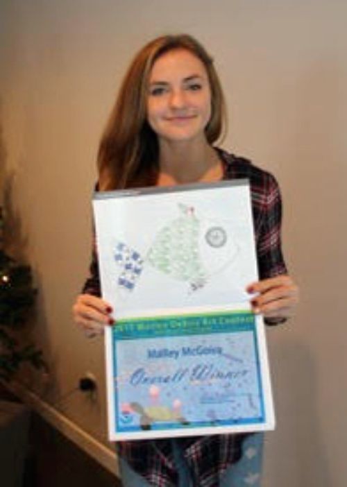 Malley M., an eighth-grade student at All Saints Catholic School in Alpena, Mich., displays her winning artwork. Malley's illustration is the November calendar page in the NOAA Marine Debris Calendar. Courtesy photo