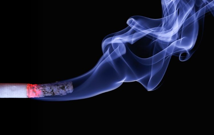 A cigarette against a black background.