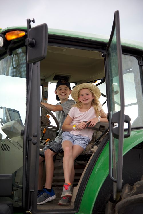Kids in a tractor.