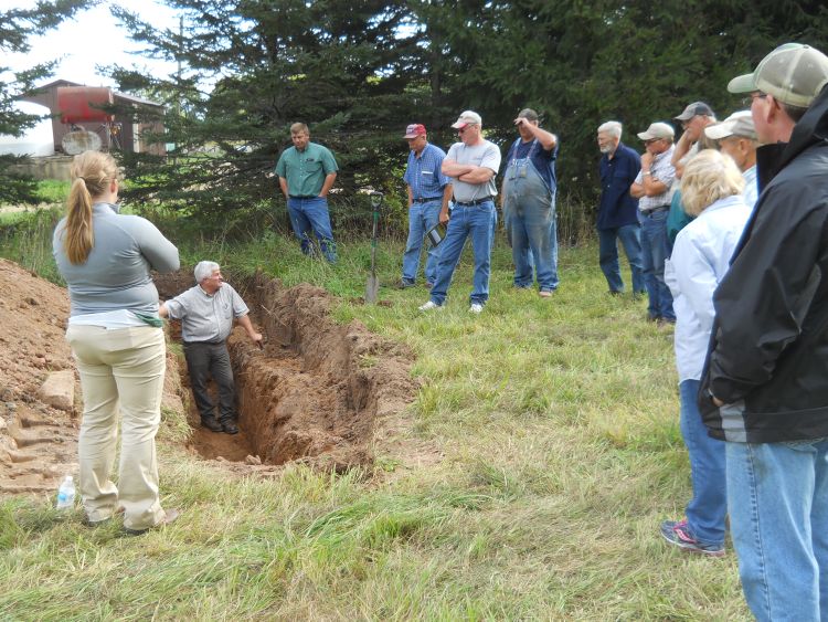 Paul Gross discusses soil health issues from a soil trench in Rumely, Michigan, at field day on Sept. 13, 2016.