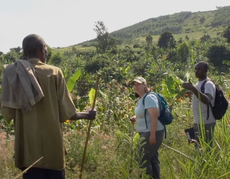 Dr. Tiemann and Kenyan farmers survey a site for its potential for growing crops.