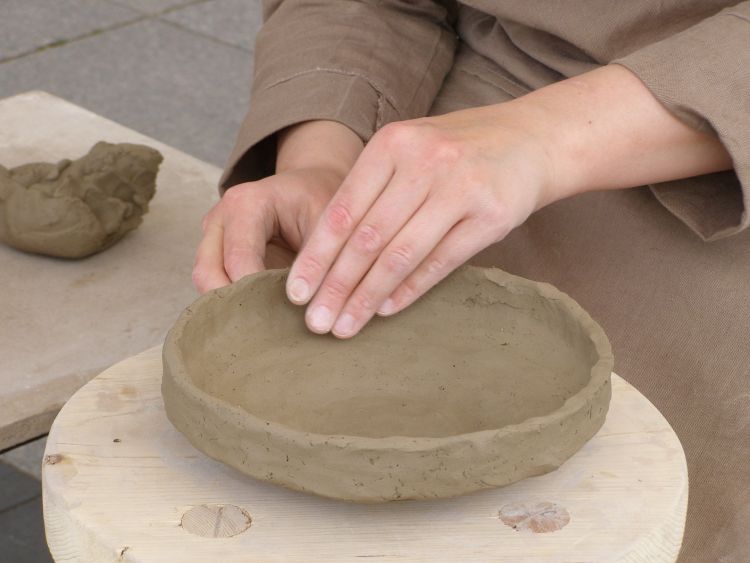 A bowl being made out of clay.