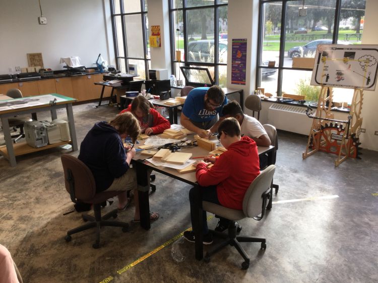 Muskegon County 4-H Tech Wizards participants learning problem-solving while working alongside college staff members and students at Muskegon Community College.