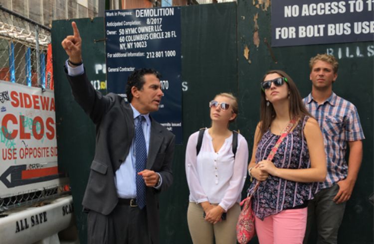 Peter Riguardi points out details to three SPDC students during a tour of Hudson Yards in New York City.