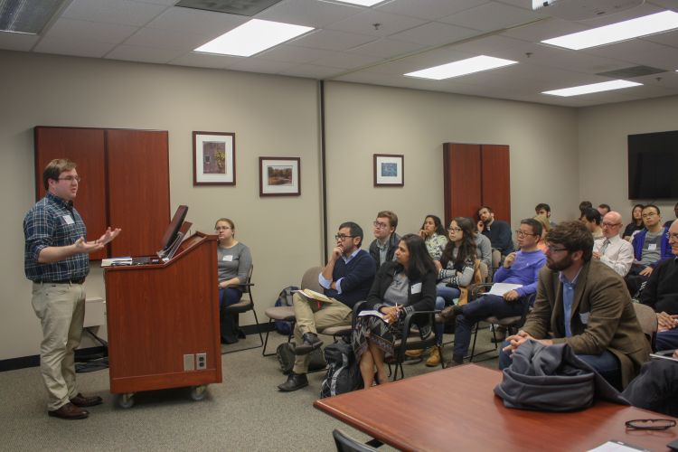 AFRE PhD student Stephen Morgan presents to a full room at the AFRE Graduate Research Symposium.