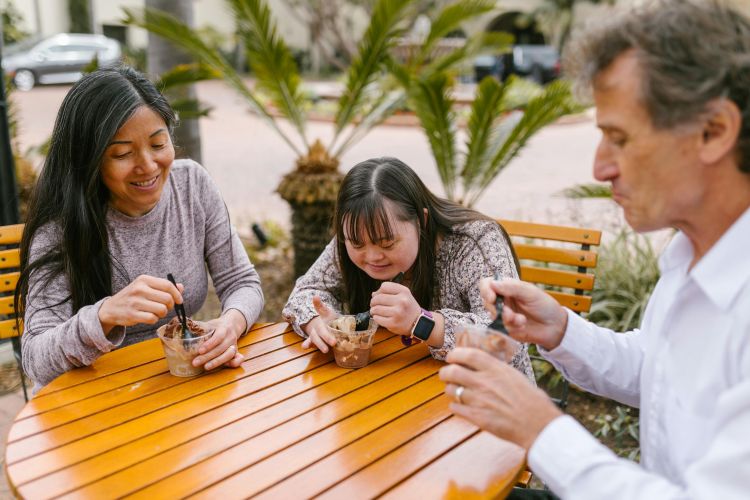 A family eating ice cream outside.