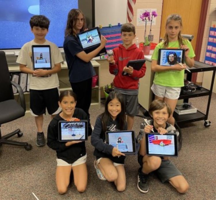 A group of CODE program participants showing off what they created on their tablets.