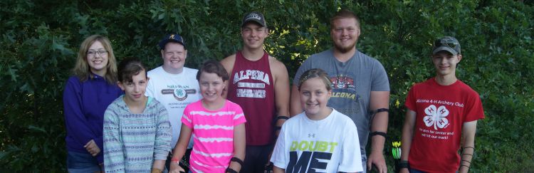 Youth with 4-H t-shirts smile.