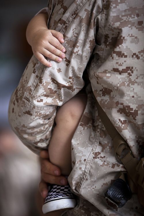 Military dad holding kid